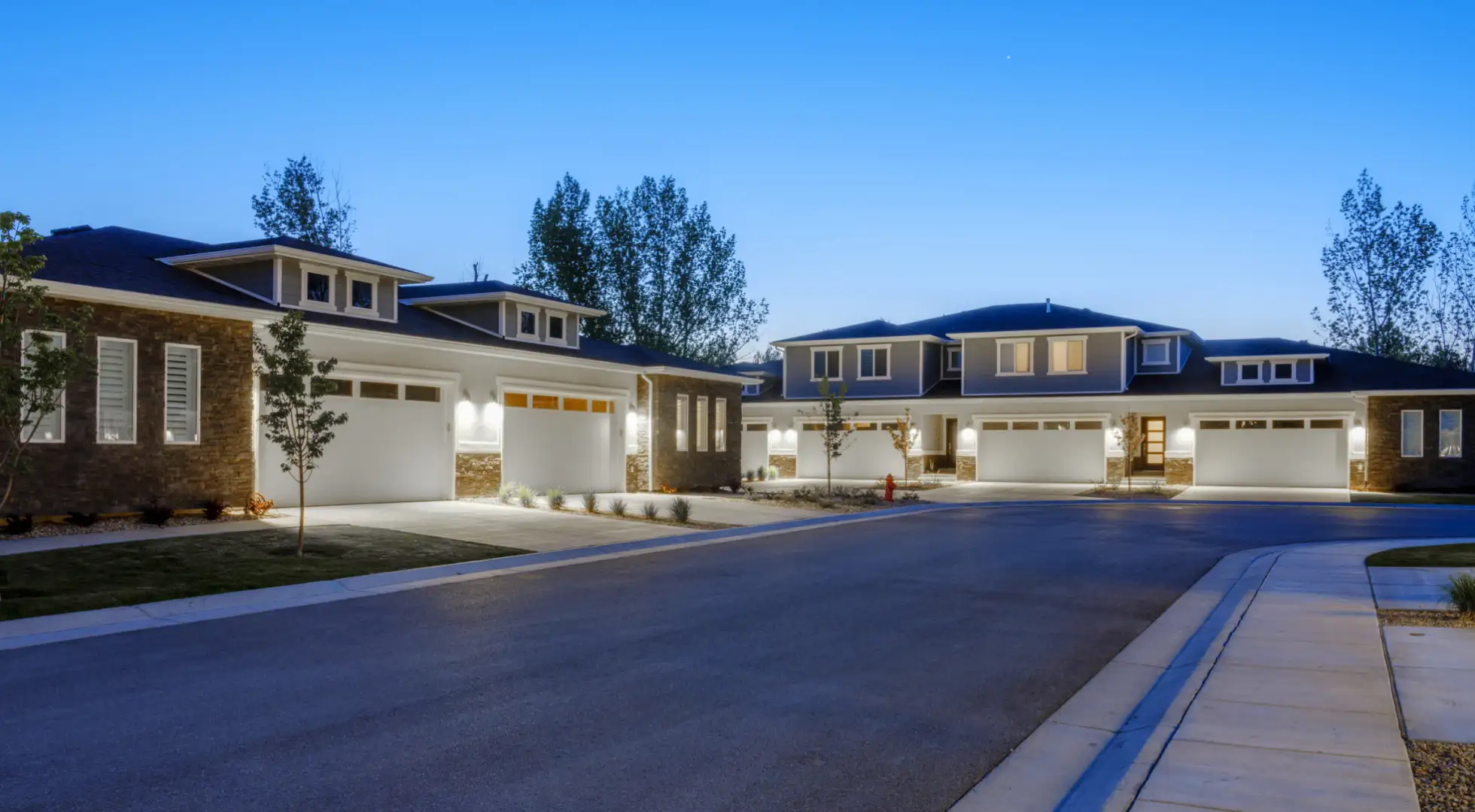 Modern multiunit properties with stone accents in a suburban setting.