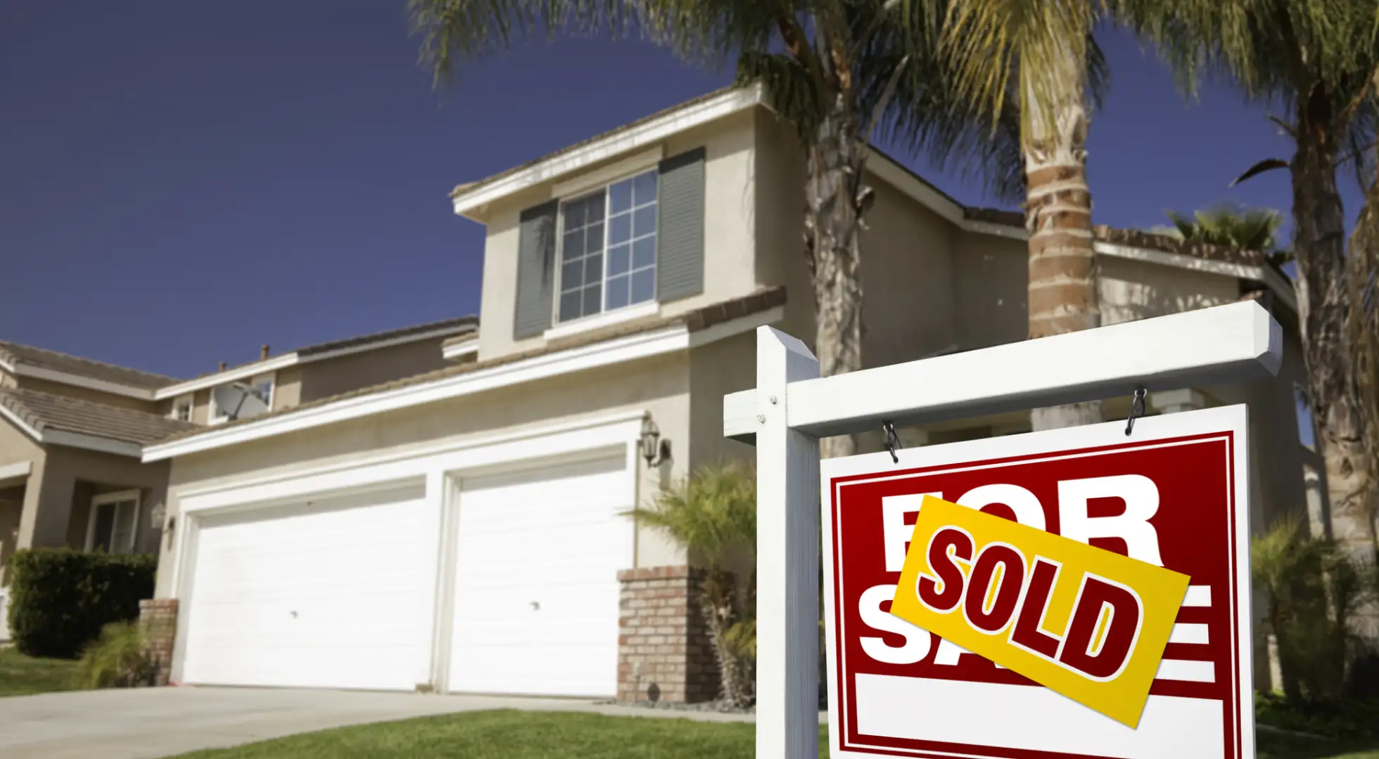 House with for sale sign in yard