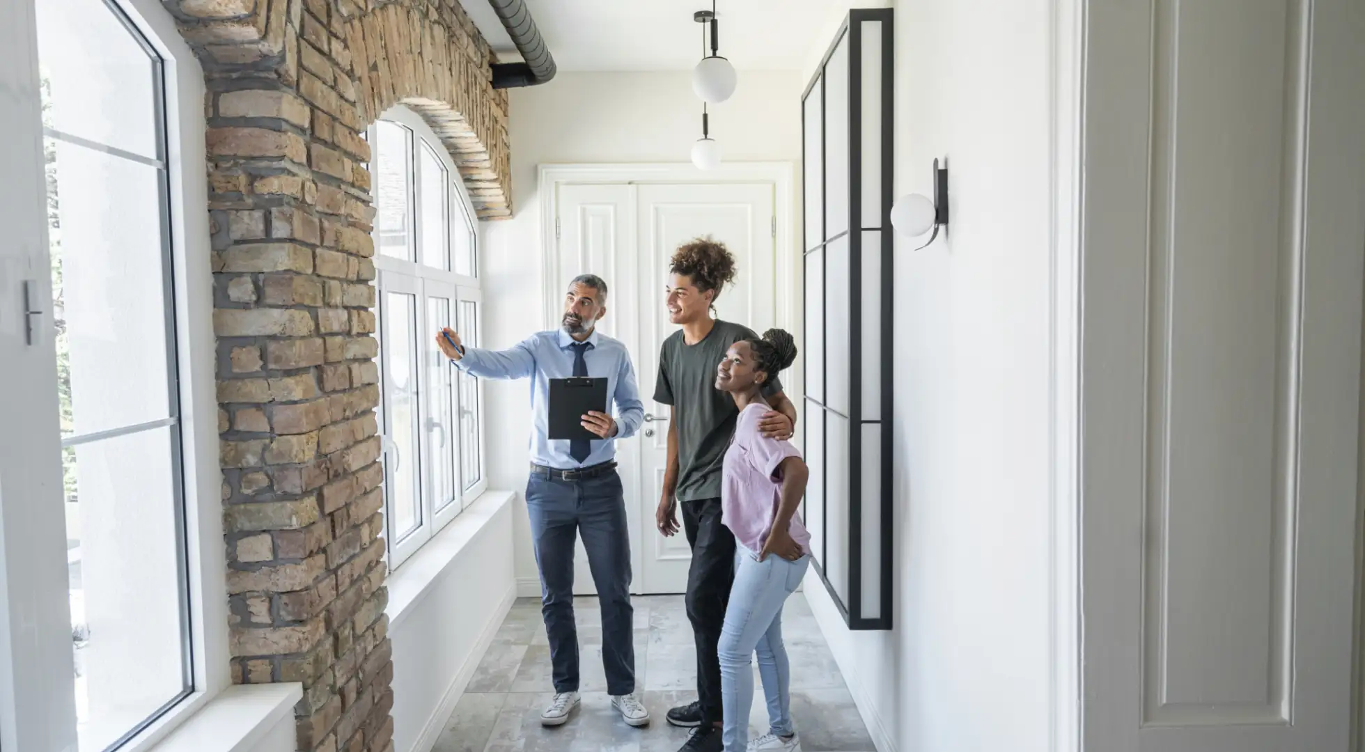 Real estate agent showing a couple a home