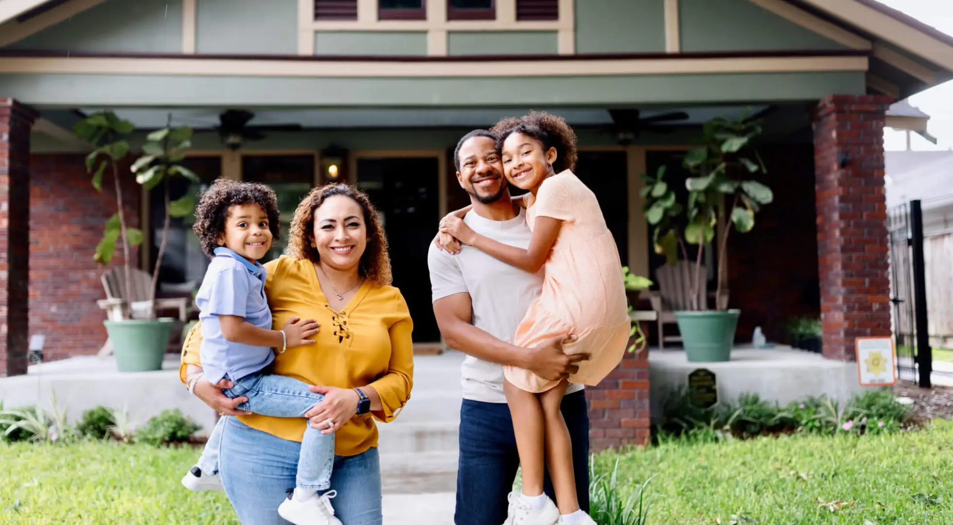 Family standing in front of new home.