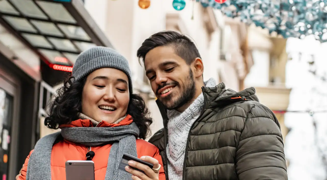 Boosting your credit score to improve your chances of getting a VA home loan Couple checks credit card balance.
