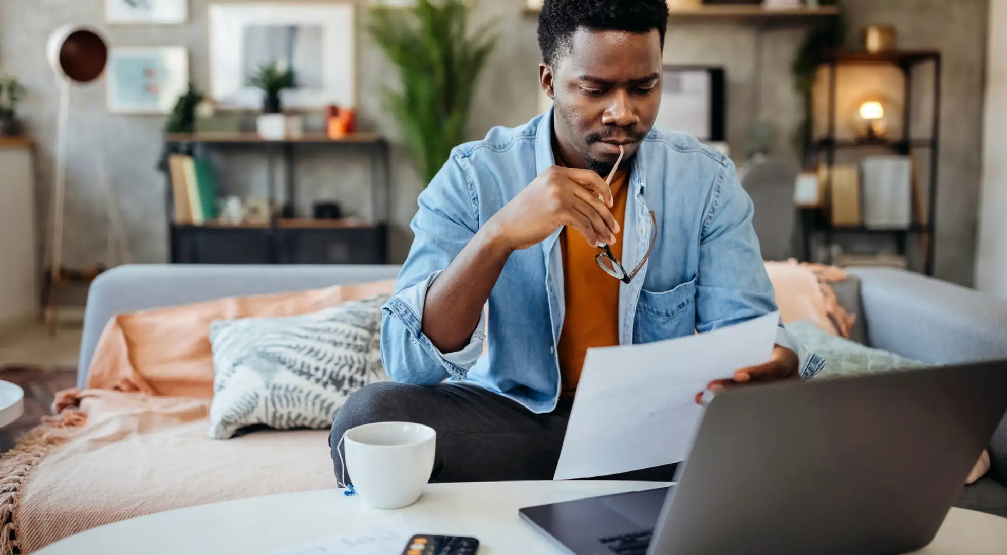 Man studies interest rate paperwork for a mortgage