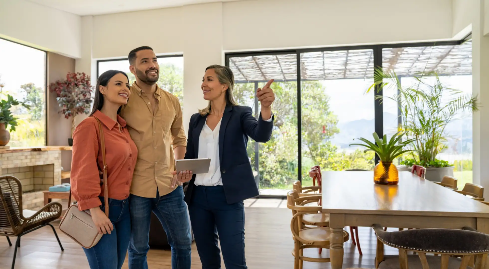 real estate agent showing a home to two first-time buyers