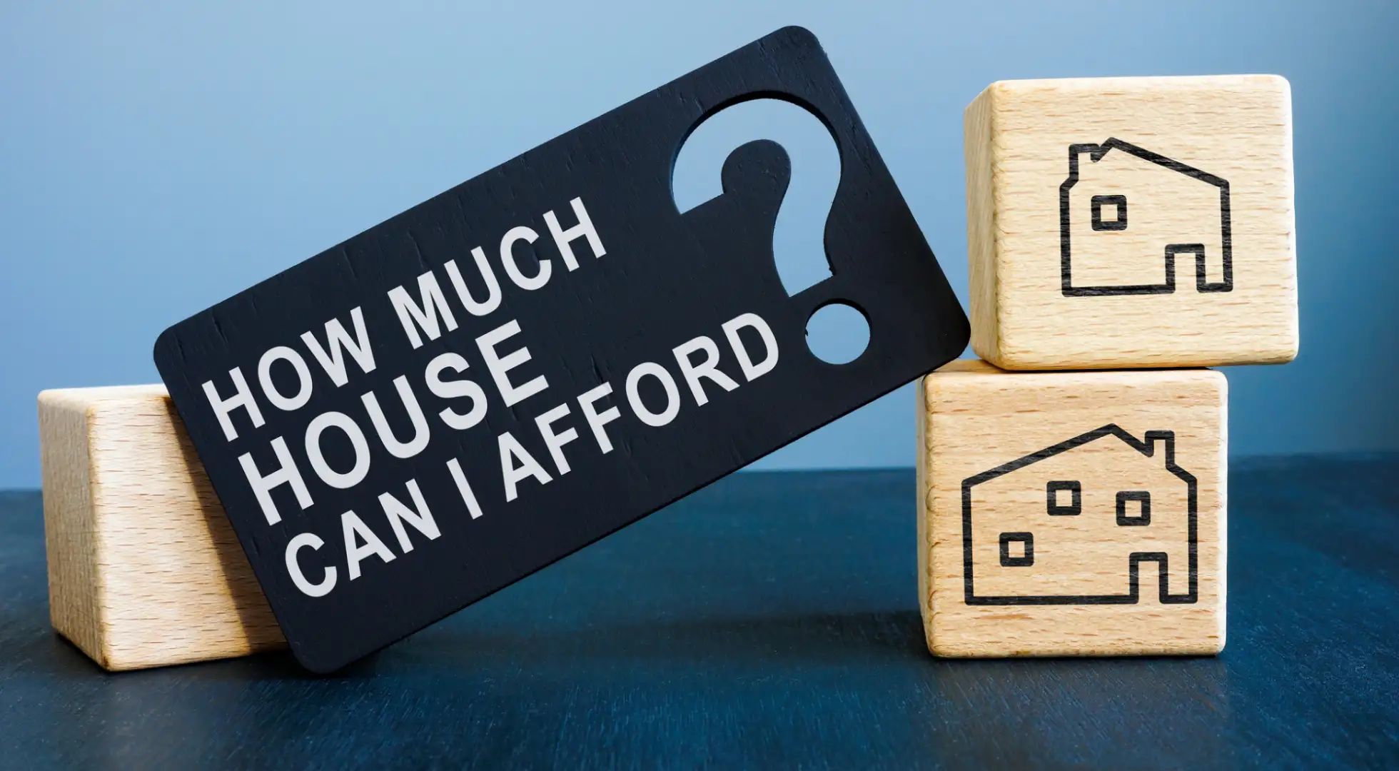 title of how much house can i afford surrounded by wood blocks with homes on them