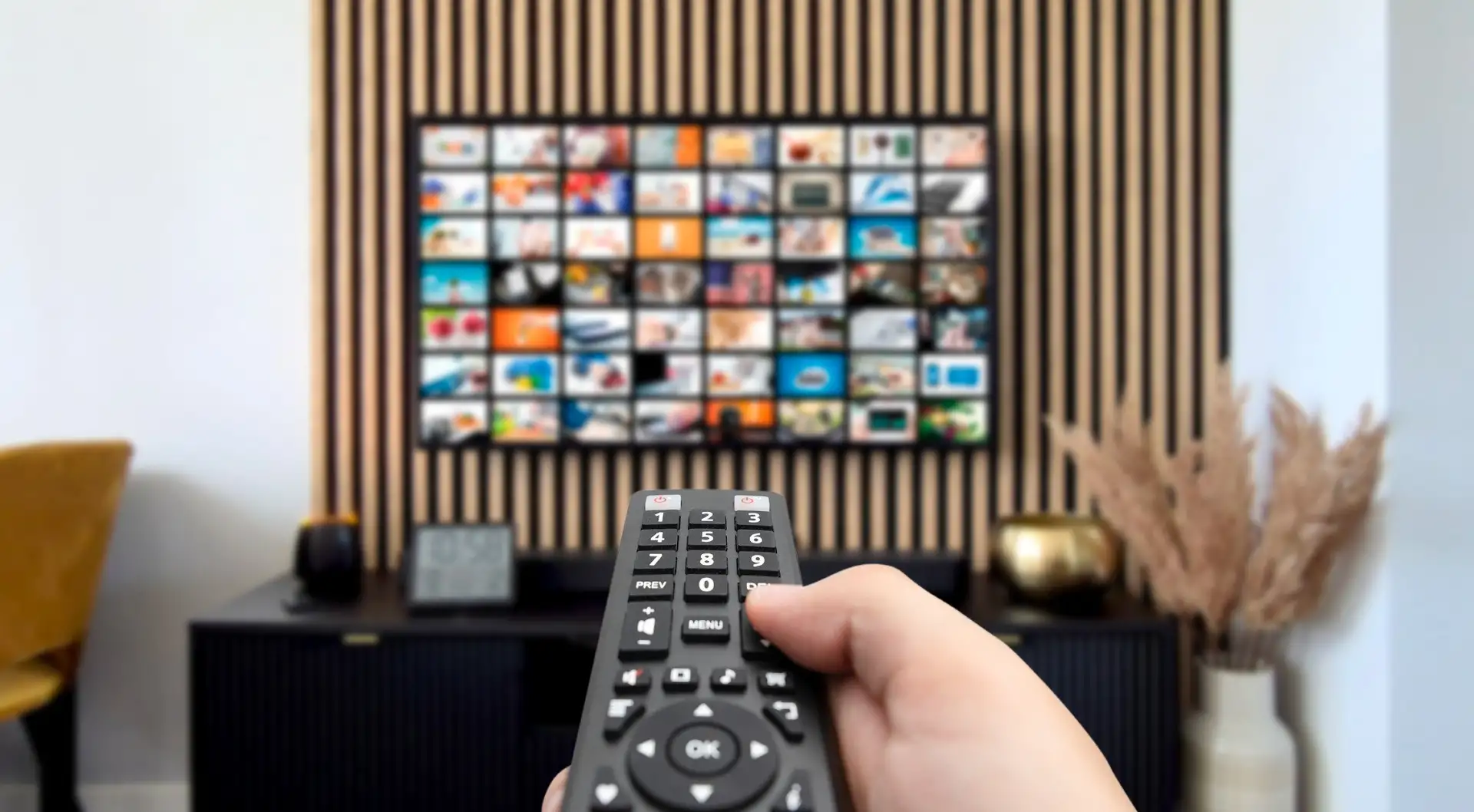 A remote control pointed at a streaming enabled TV