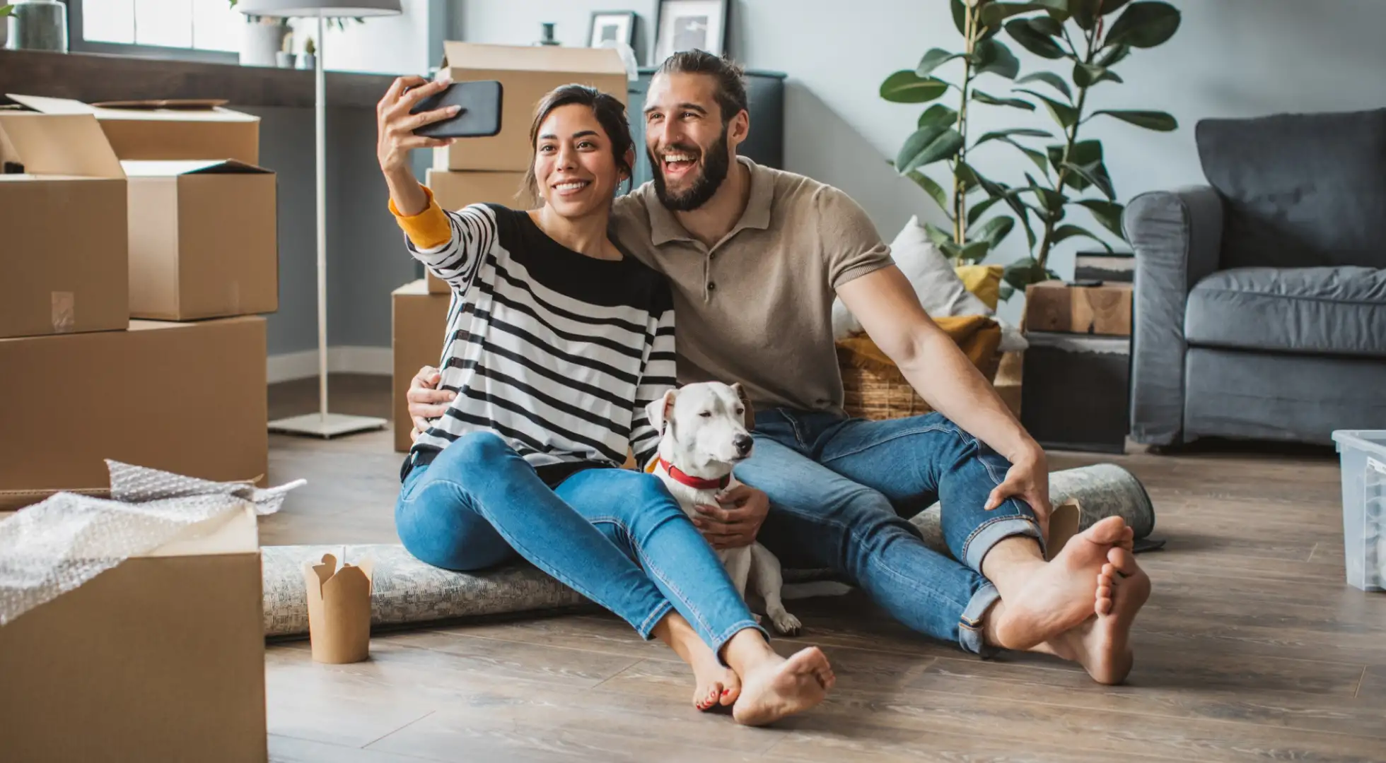 couple taking a photo in their new phone: buying a home you can keep