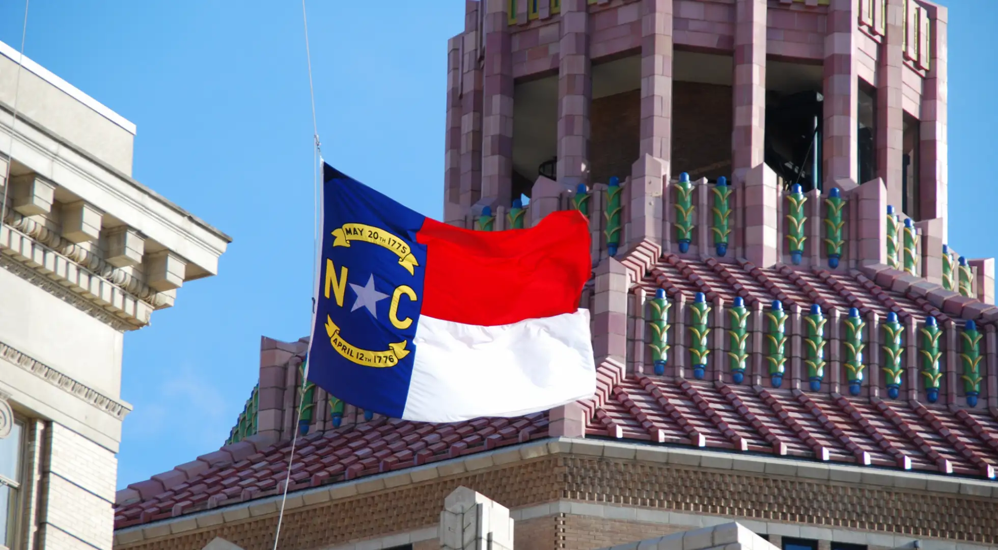 north carolina flag in front of historic building