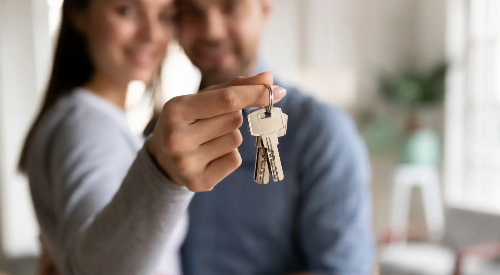 Young couple holding keys