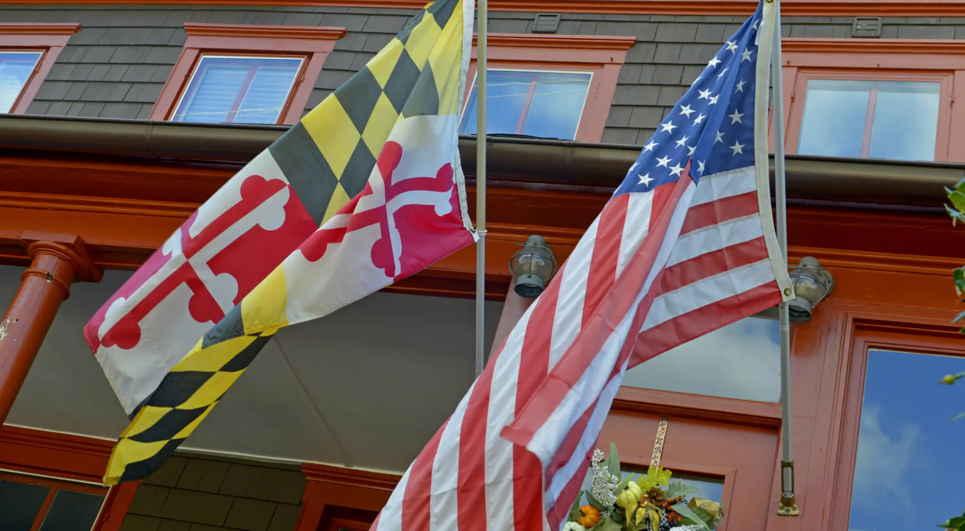 maryland and us flags in front of a home: down payment assistance