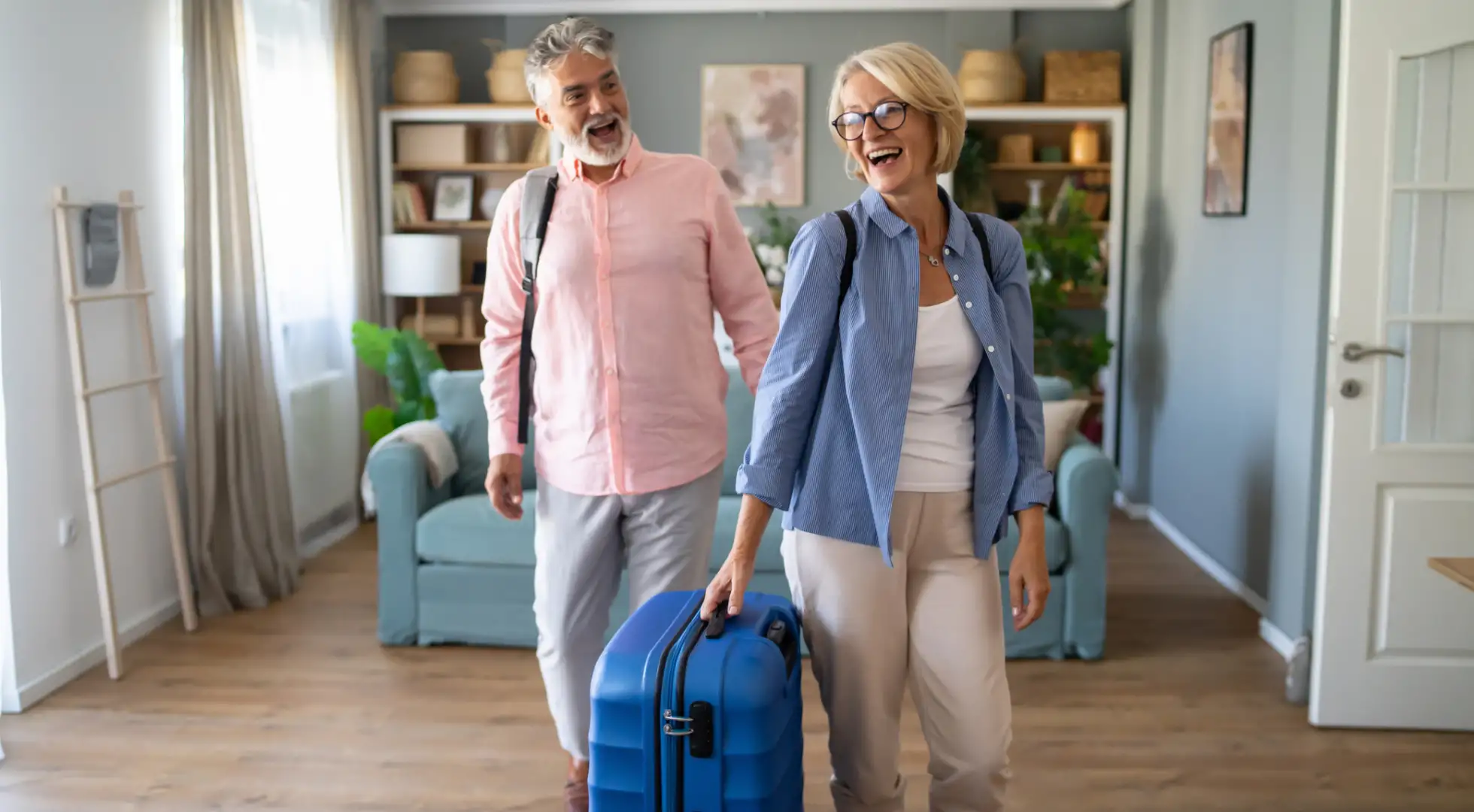 couple with luggage walking into their vacation home
