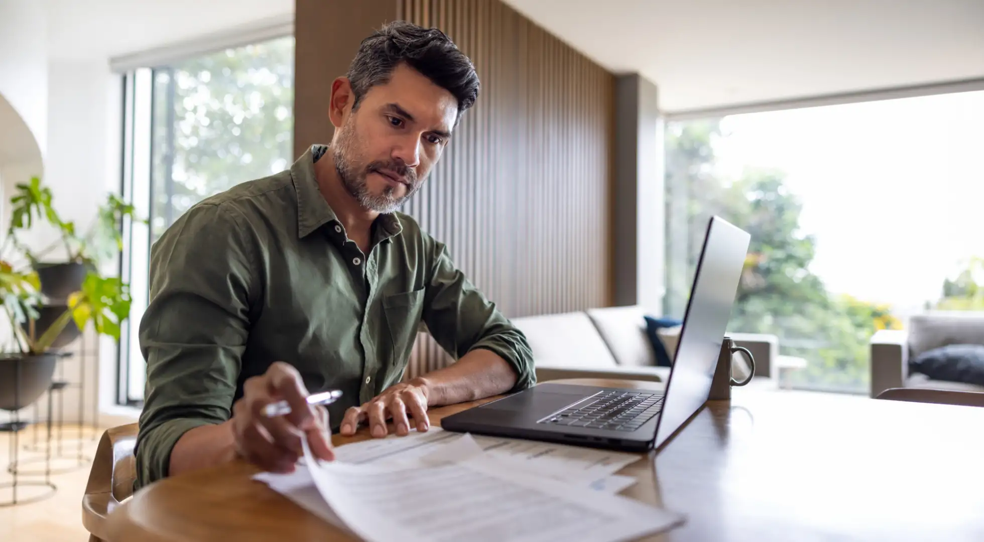 real estate investor at his desk comparing loan options: no-qm