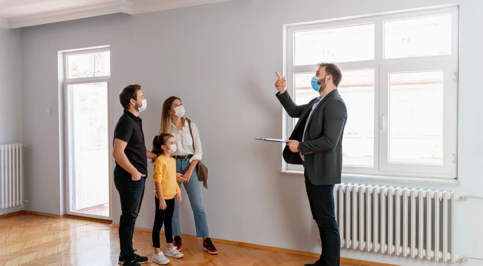 Homebuying Sentiment Falls to All-Time Low, Fannie Mae Survey Shows family looking at home with real estate agent