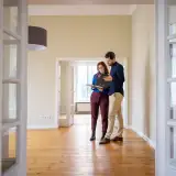 Home appraiser reviewing findings with real estate agent.