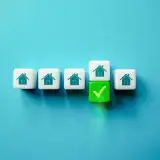Row of house icons. One has a checkmark under it.