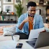 Man studies interest rate paperwork for a mortgage