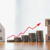 home and an upward arrow representing rising property taxes