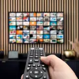 A remote control pointed at a streaming enabled TV