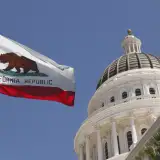 california capital building with state flag: down payment assistance programs