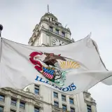 Illinois state flag in front of the Wrigley building