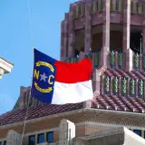 north carolina flag in front of historic building