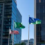 us, washington, and bellevue flags in front of downtown buildings: down payment assistance washington