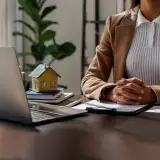 loan officer sitting behind a desk: largest refinance lenders