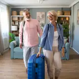 couple with luggage walking into their vacation home