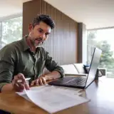 real estate investor at his desk comparing loan options: no-qm
