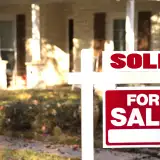 House with sold sign: mortgage rates