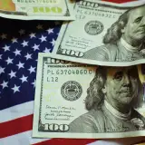 $100 bills and U.S. flag