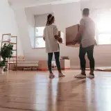 A couple standing in a living room
