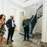Landmark Verdict Has Homebuyers Asking ‘Do I Need a Buyer’s Agent?’ First-time homebuyers walking through potential new home with real estate agent.