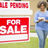 pending home sale sign with real estate agent