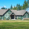 Attractive home in a rural area with a large yard, surrounded by trees
