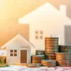 Stack of coins in front of a house icon