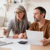 A mature couple reviewing FHA mortgage insurance premiums.