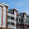 How to Get an FHA Single-Unit "Spot" Approval for a Condo A modern condominium building with red brick and metal accents.