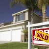 House with for sale sign in yard