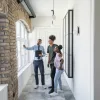 Real estate agent showing a couple a home