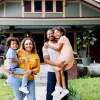 Family standing in front of new home.