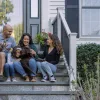 Family on steps in front of home