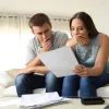 Distressed couple looking at homebuying budget