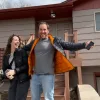 Ryan Thomson and partner Jennifer Bohle celebrate outside their hacked home.