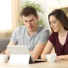 Confused homebuyers looking at an iPad.
