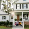 Family on front steps of home