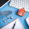 Home and shopping cart on top of computer desk next to keyword and mouse