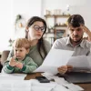 Young family stressed out while looking at paperwork.