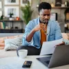 Man studies interest rate paperwork for a mortgage