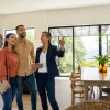 real estate agent showing a home to two first-time buyers