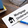 desk with a document titled mortgage underwriting